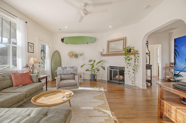 living room featuring ceiling fan and hardwood / wood-style floors