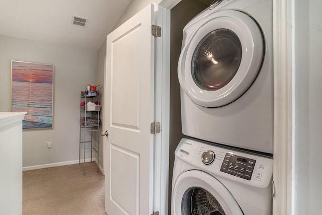 134 Alma Dr, Ladson, SC 29456 - clothes washing area with stacked washer and clothes dryer, visible vents, light carpet, laundry area, and baseboards