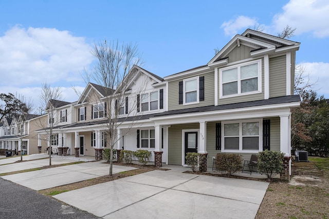 multi unit property with a residential view, central AC unit, a porch, and board and batten siding