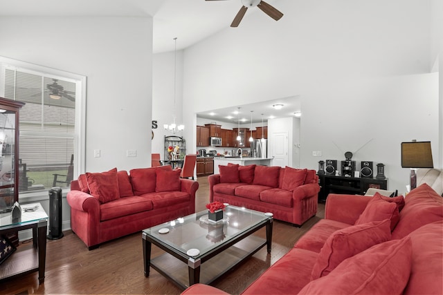 living room with a ceiling fan, high vaulted ceiling, and wood finished floors