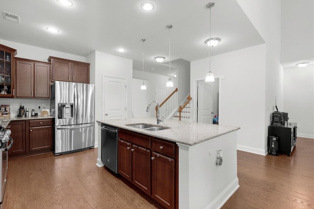 kitchen featuring dark wood-style flooring, stainless steel appliances, visible vents, and a sink