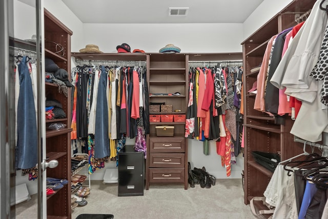 walk in closet featuring carpet flooring and visible vents