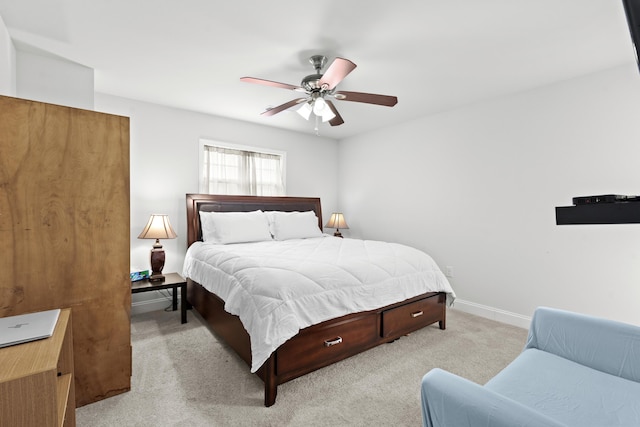 bedroom featuring baseboards, light carpet, and a ceiling fan