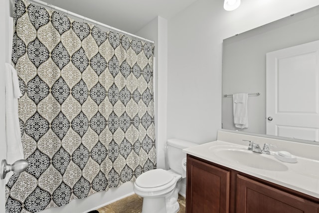 bathroom featuring vanity, toilet, and a shower with shower curtain