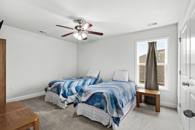 carpeted bedroom featuring baseboards, ceiling fan, and visible vents