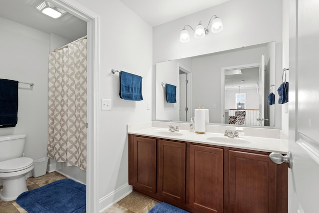 full bathroom featuring a sink, tile patterned flooring, toilet, and double vanity