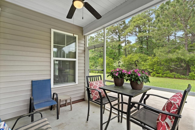 sunroom featuring ceiling fan and outdoor dining area