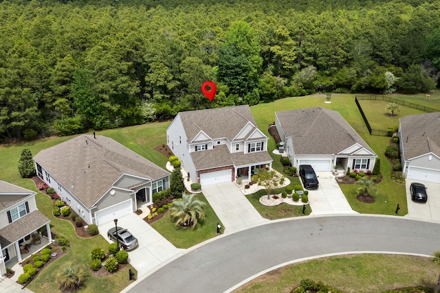 drone / aerial view with a residential view and a view of trees
