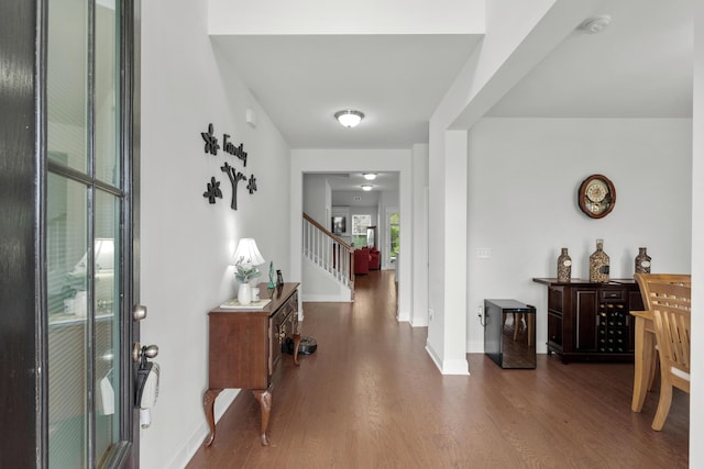 entryway with baseboards, stairs, and wood finished floors