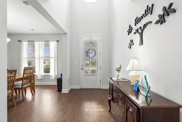 entrance foyer featuring dark wood-style flooring, baseboards, and visible vents