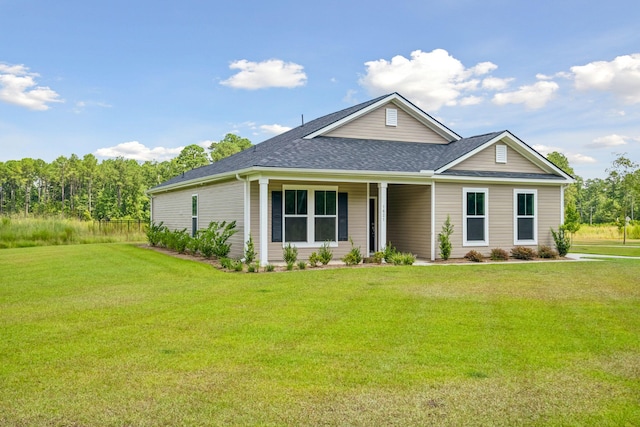 view of front of property with a shingled roof and a front yard