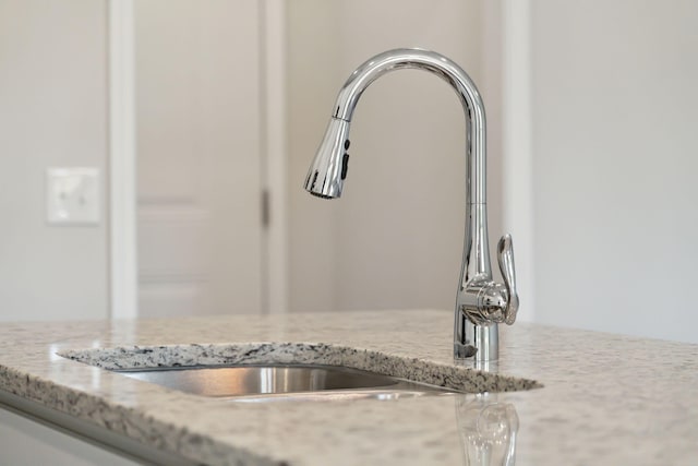 details featuring sink and light stone counters