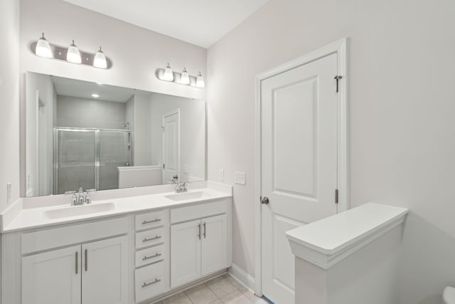 bathroom with walk in shower, vanity, and tile patterned floors