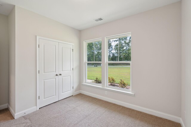 carpeted spare room with a healthy amount of sunlight