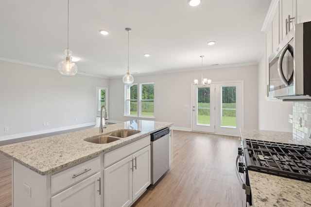 kitchen with appliances with stainless steel finishes, light wood-style floors, crown molding, and a sink