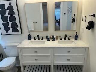 bathroom featuring vanity and toilet