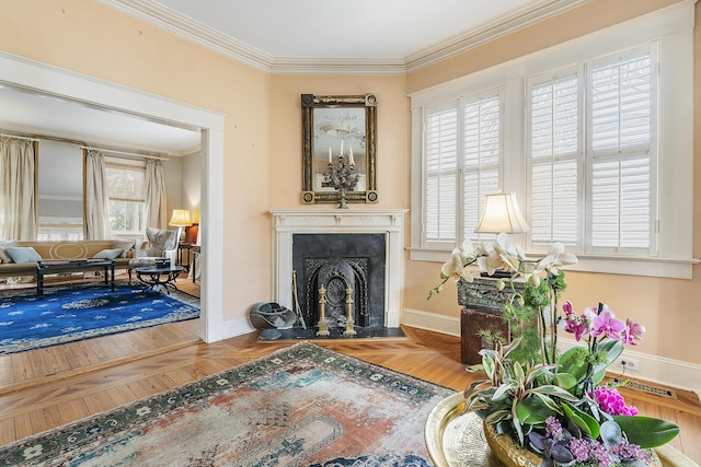 sitting room with baseboards, a fireplace with flush hearth, and crown molding