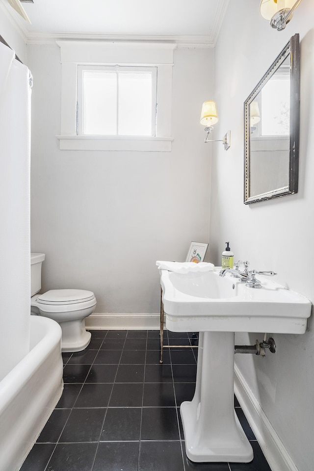 bathroom featuring toilet, baseboards, crown molding, and tile patterned floors