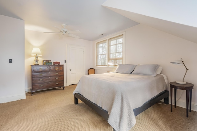 bedroom featuring lofted ceiling, ceiling fan, light carpet, and baseboards