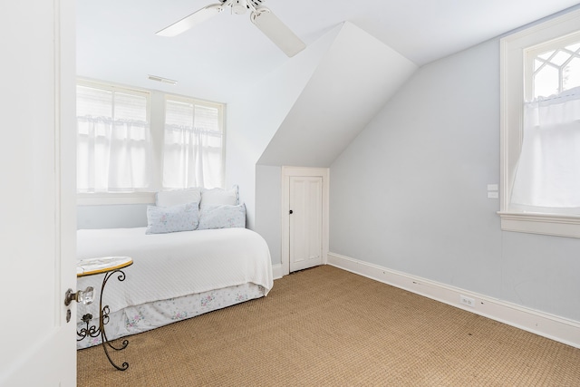 bedroom with baseboards, visible vents, ceiling fan, vaulted ceiling, and carpet flooring