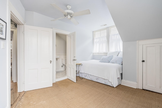 bedroom with lofted ceiling, ceiling fan, visible vents, and light colored carpet