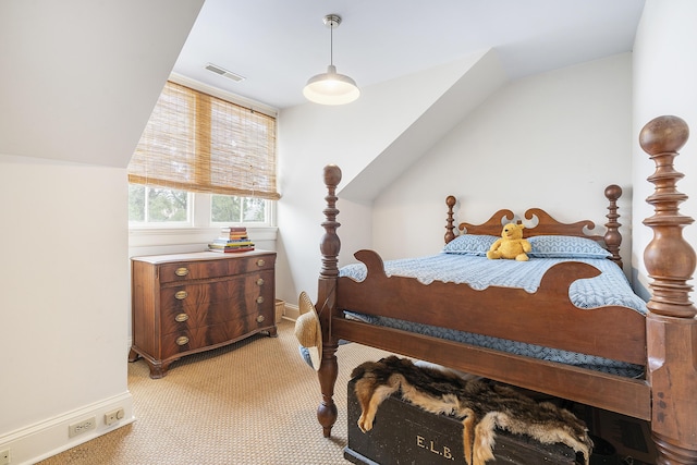 bedroom featuring visible vents, vaulted ceiling, light carpet, and baseboards