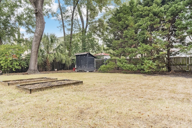 view of yard with an outbuilding, a fenced backyard, and a shed