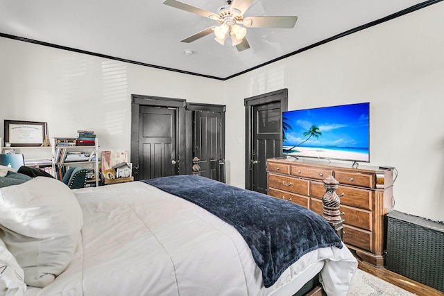 bedroom featuring ornamental molding, ceiling fan, and hardwood / wood-style flooring