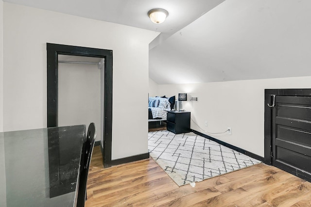 interior space featuring light hardwood / wood-style flooring and vaulted ceiling