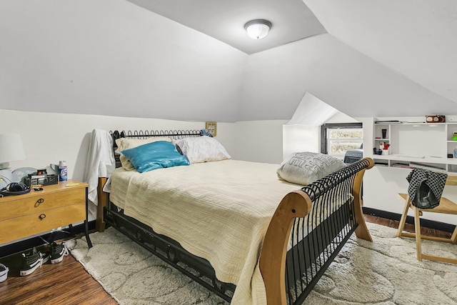 bedroom with lofted ceiling and hardwood / wood-style flooring