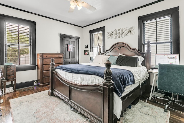 bedroom with ceiling fan, ornamental molding, and dark wood-type flooring