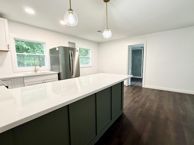 208 Orange St, Walterboro, SC 29488 - kitchen featuring freestanding refrigerator, a sink, dark wood-type flooring, decorative light fixtures, and light countertops