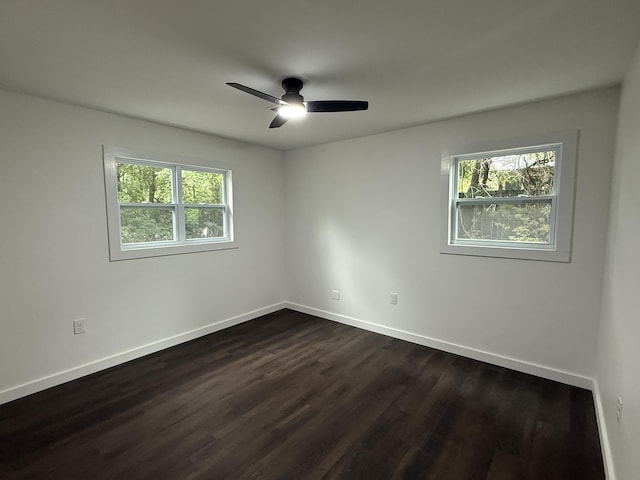 208 Orange St, Walterboro, SC 29488 - spare room featuring dark wood finished floors, a ceiling fan, and baseboards