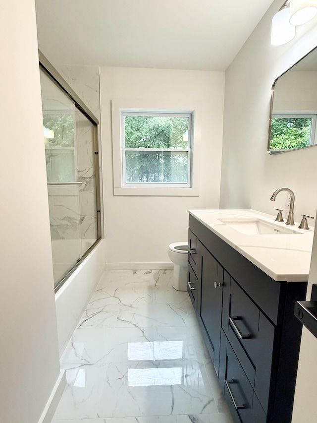 208 Orange St, Walterboro, SC 29488 - bathroom with toilet, marble look tile flooring, vanity, baseboards, and bath / shower combo with glass door