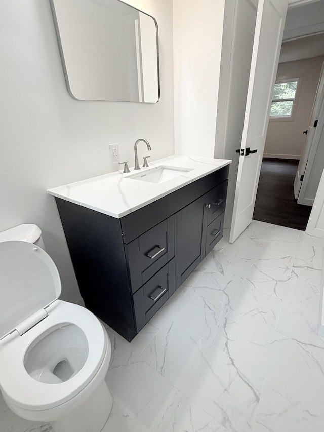 208 Orange St, Walterboro, SC 29488 - half bathroom featuring vanity, toilet, and marble finish flooring