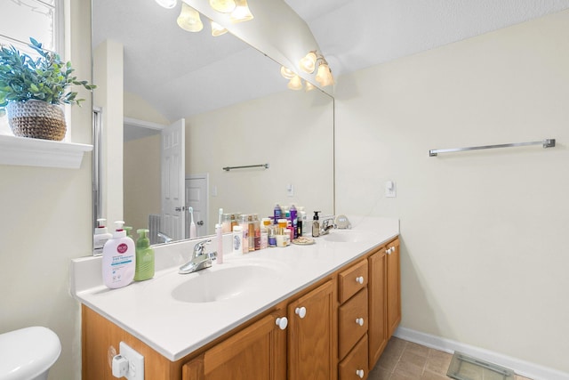 bathroom with vanity, toilet, and tile patterned flooring