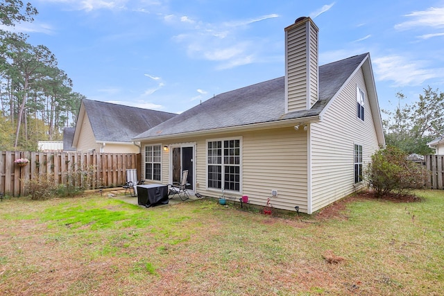 rear view of house featuring a patio and a yard