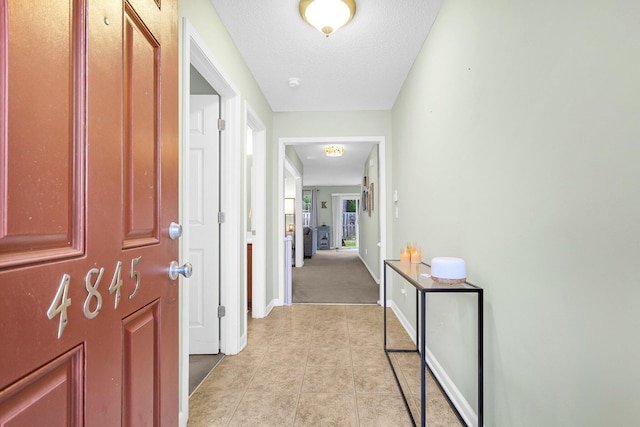 hallway featuring light tile patterned floors