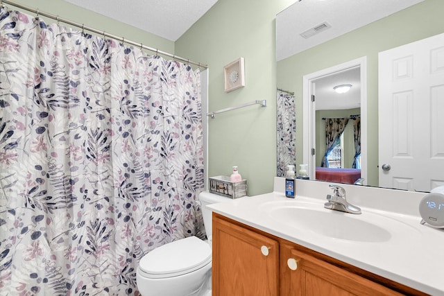 bathroom featuring vanity, a shower with shower curtain, a textured ceiling, and toilet