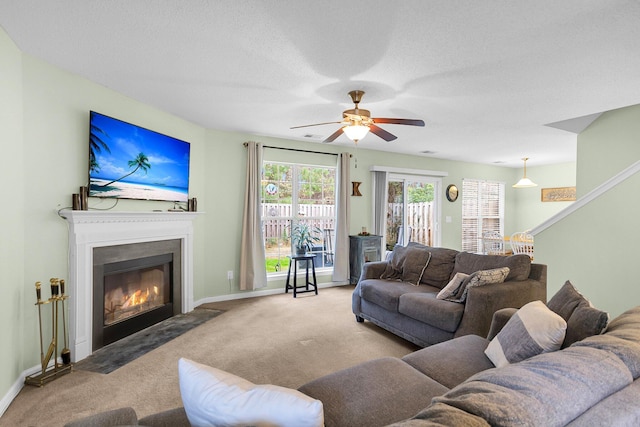 carpeted living room featuring ceiling fan