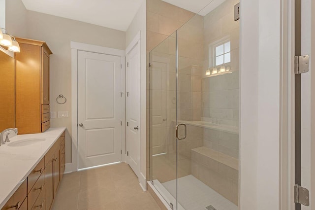 bathroom with vanity, tile patterned floors, and a shower with door