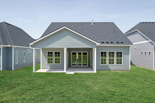 rear view of property featuring a patio area and a lawn