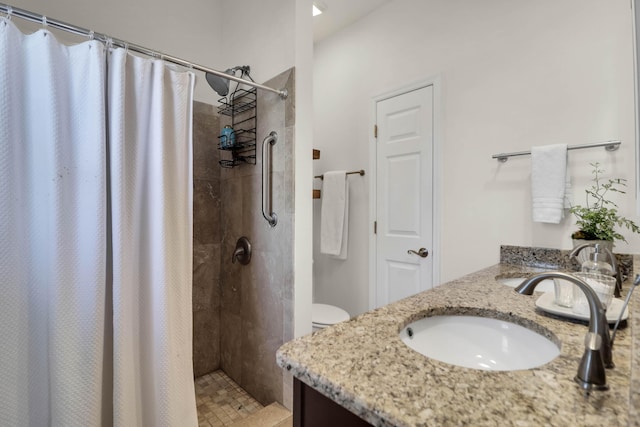 full bath with a tile shower and vanity