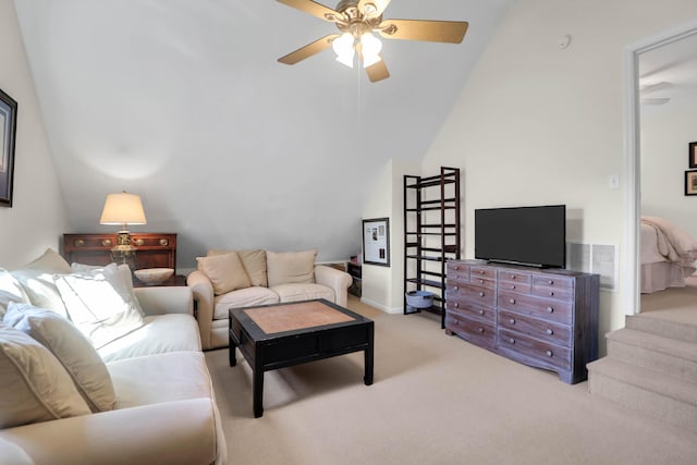 living room with a ceiling fan, light colored carpet, vaulted ceiling, and visible vents