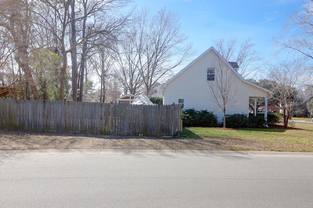 view of home's exterior with fence