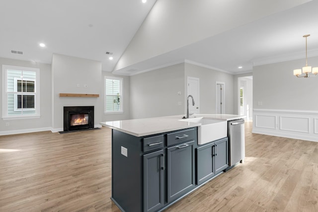 710 Minton Rd, James Island, SC 29412 - kitchen with a fireplace with flush hearth, light wood finished floors, stainless steel dishwasher, and a sink