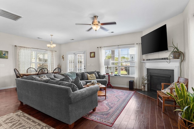 1821 Towne St, Johns Island, SC 29455 - living room featuring plenty of natural light, a chandelier, dark wood finished floors, and a fireplace with flush hearth