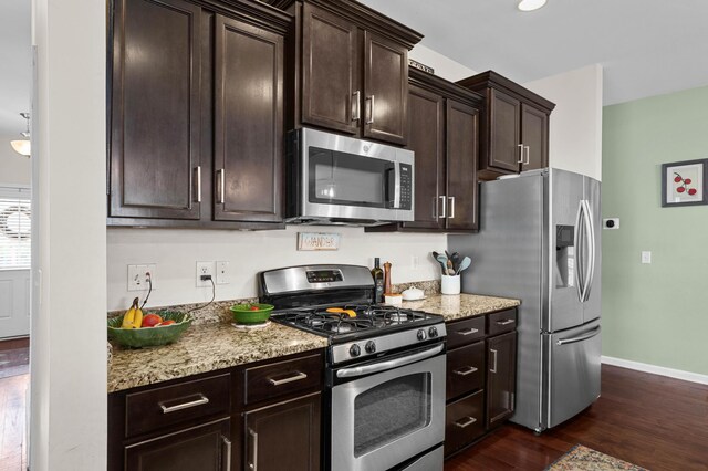 1821 Towne St, Johns Island, SC 29455 - kitchen with stainless steel appliances, dark wood-type flooring, dark brown cabinetry, and light stone counters