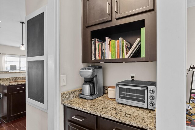 1821 Towne St, Johns Island, SC 29455 - kitchen featuring dark brown cabinetry, light stone countertops, and dark wood-style floors