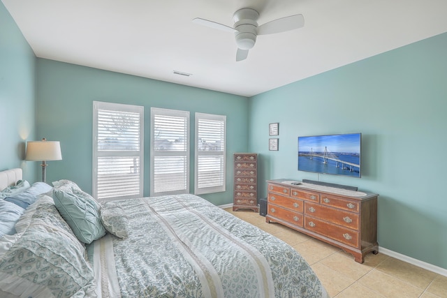 tiled bedroom featuring ceiling fan